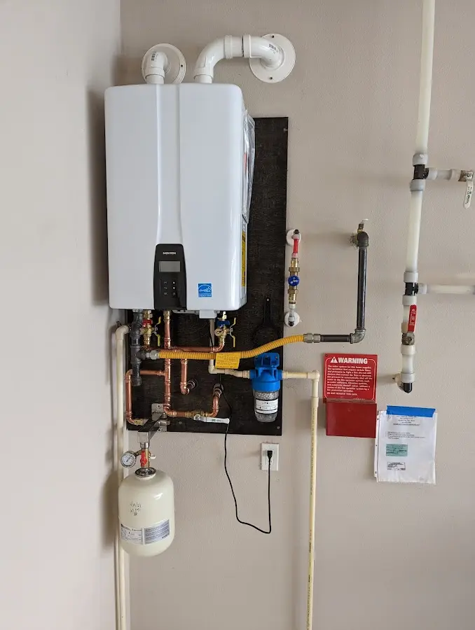 Professional plumber installing copper piping in a Lebanon home